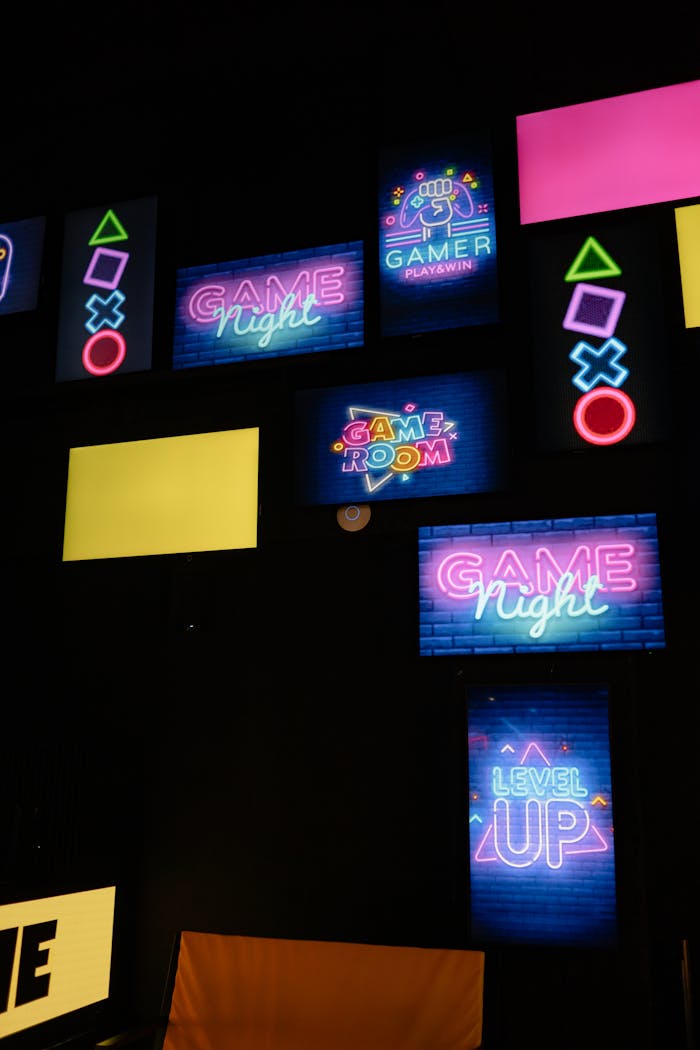 Colorful neon signs displaying gaming messages in a modern arcade setting.